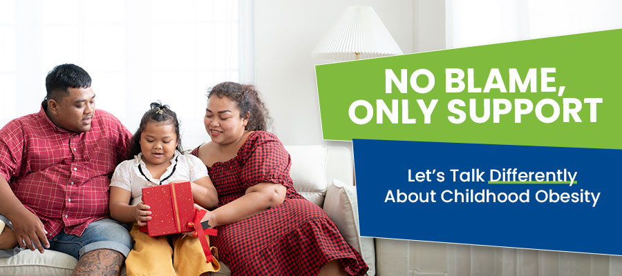 Family sitting on couch reading with child